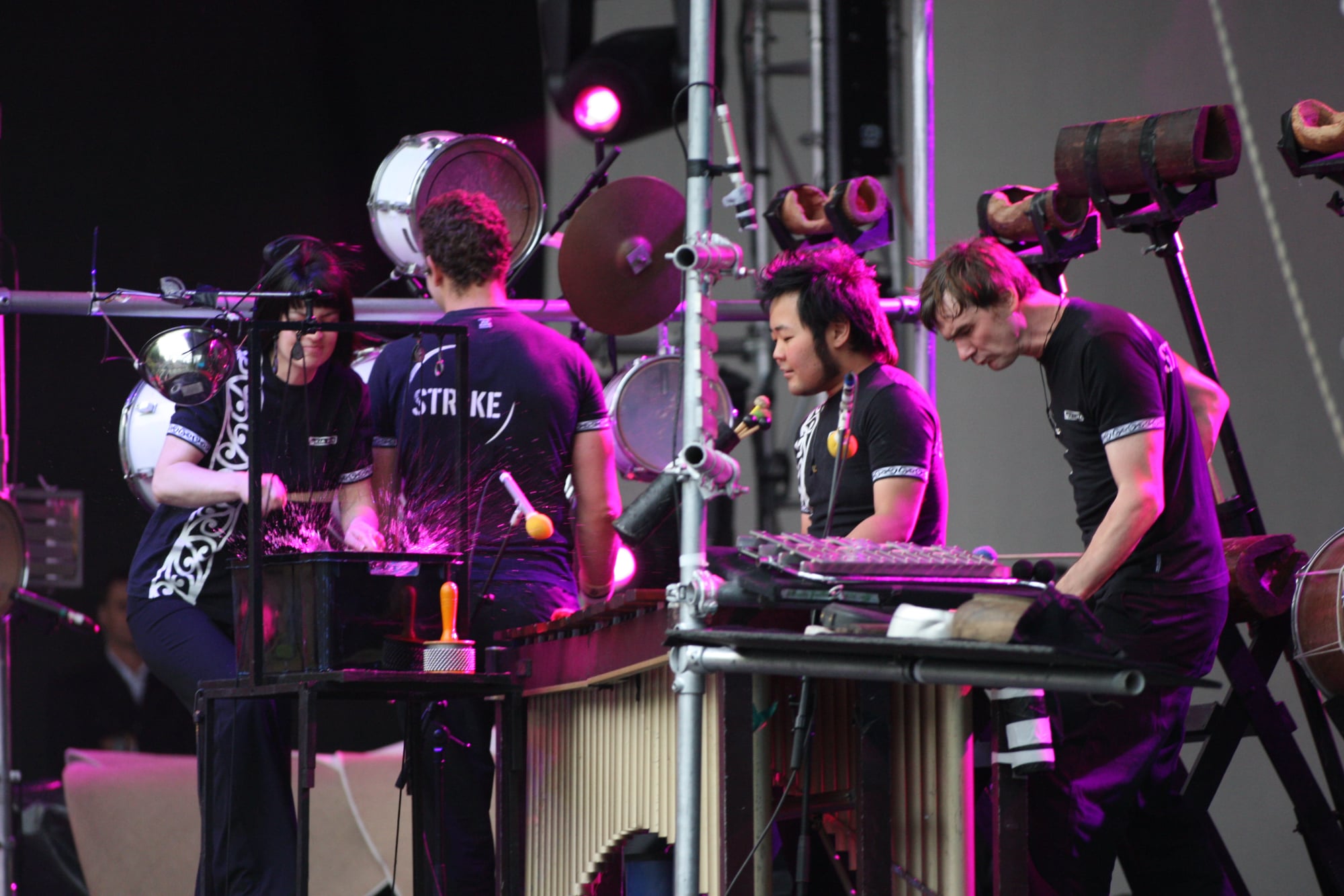 Strike Percussion performers playing large percussion instruments on stage.